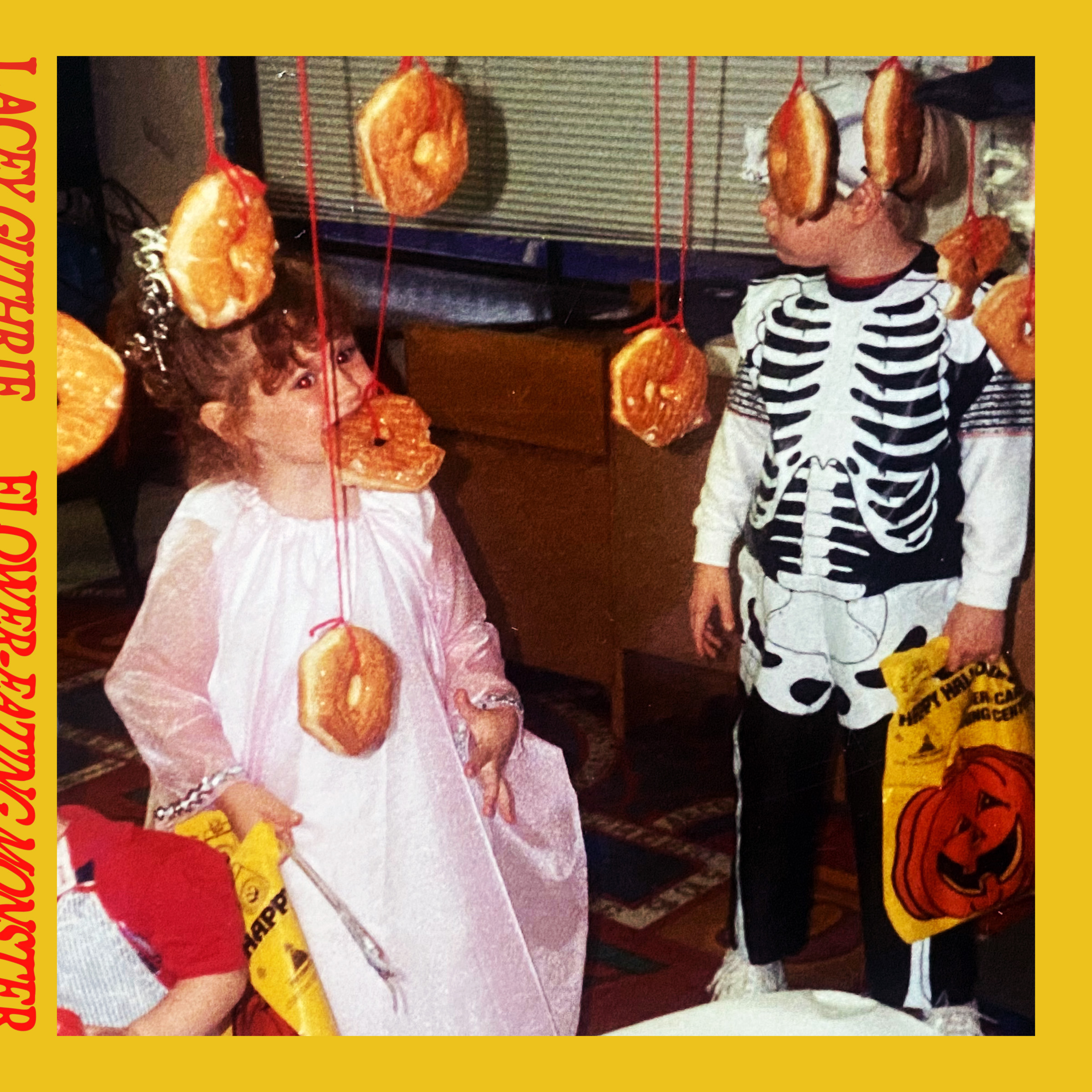 Album artwork with a mustard yellow border, red design elements, and an image of a little girl in a princess outfit eating a donut hanging from a string.