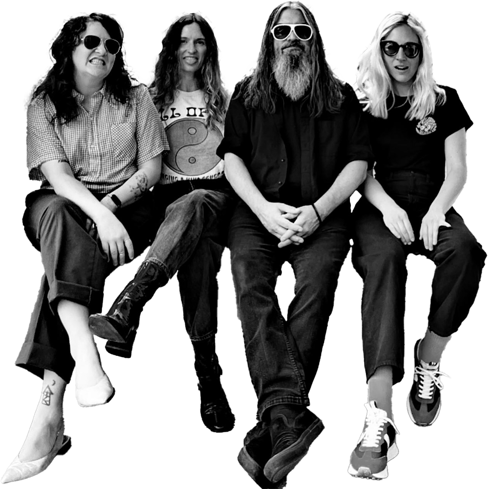 the band duchess sitting together on a porch looking at the camera