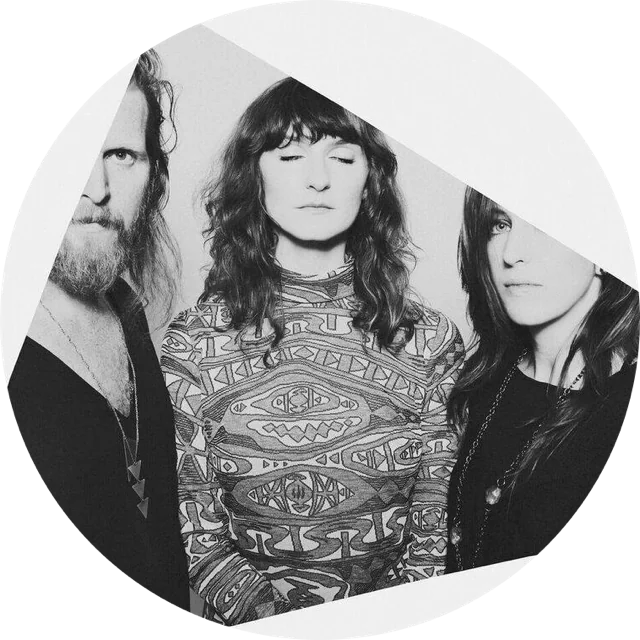 the three members of Twin Limb in black and white, close together, eyes closed or looking past the camera
